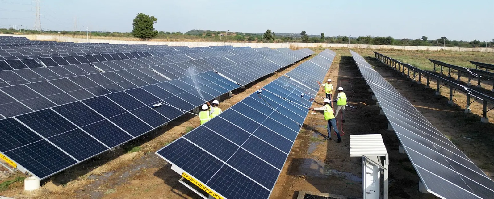 Ground-mounted solar panel array installed on open land in Tamil Nadu